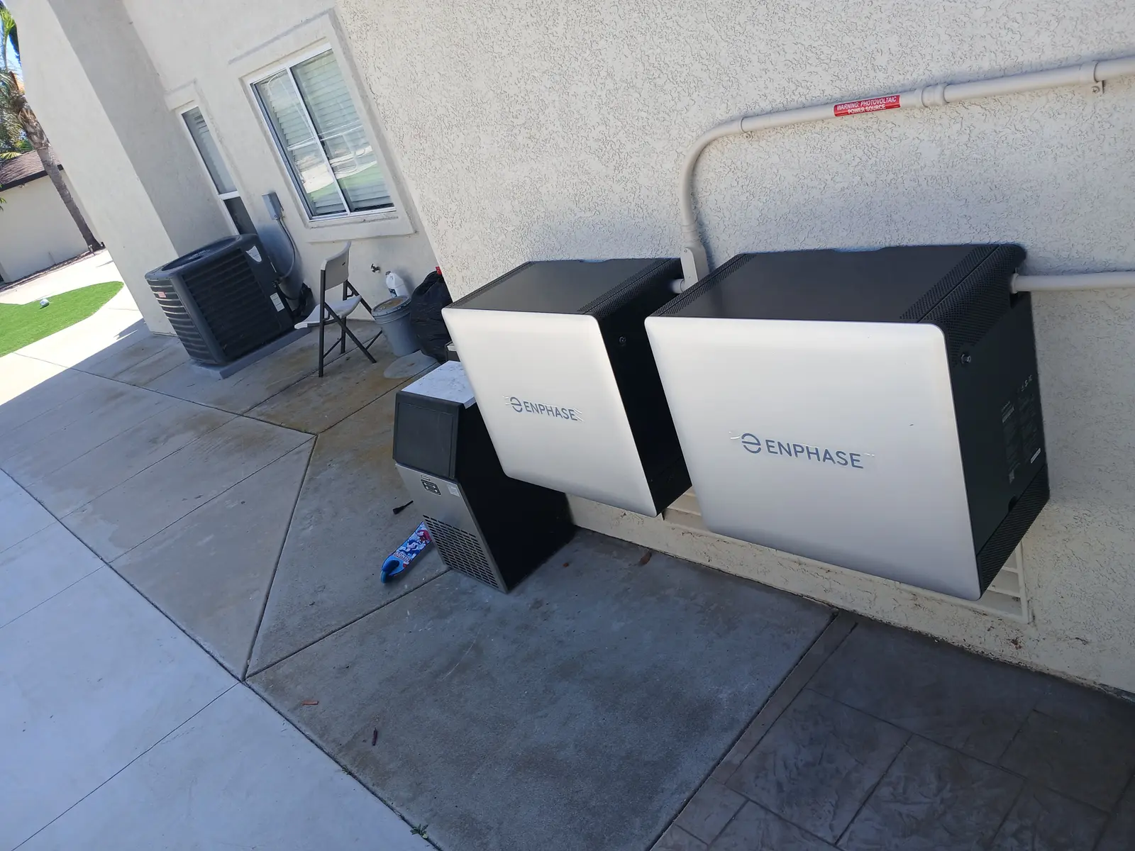 BlueWest Electric Enphase battery pair mounted on an exterior wall