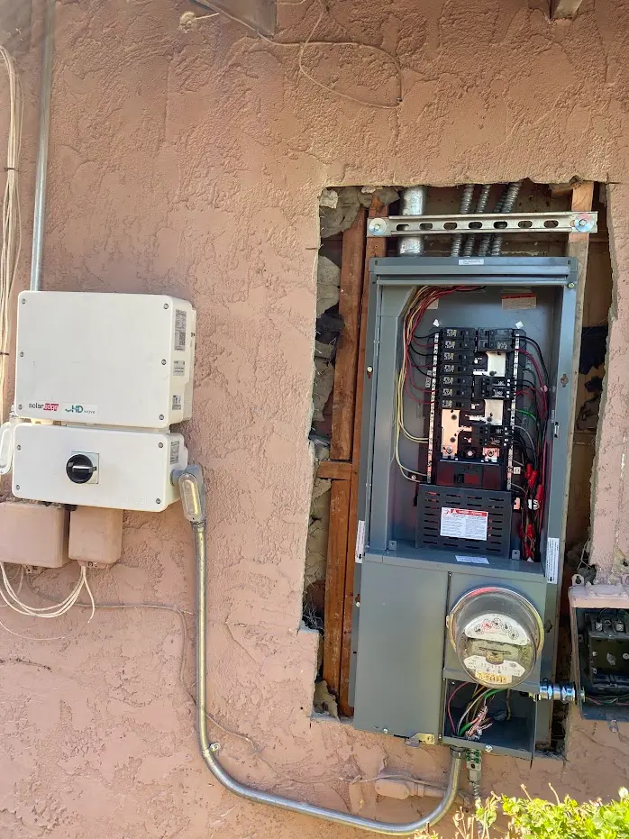 BlueWest Electric panel upgrade in progress with a SolarEdge inverter beside it